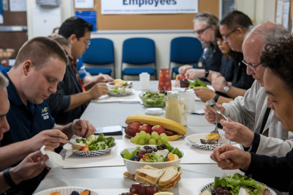 Night shift workers eating a meal in the break room together.