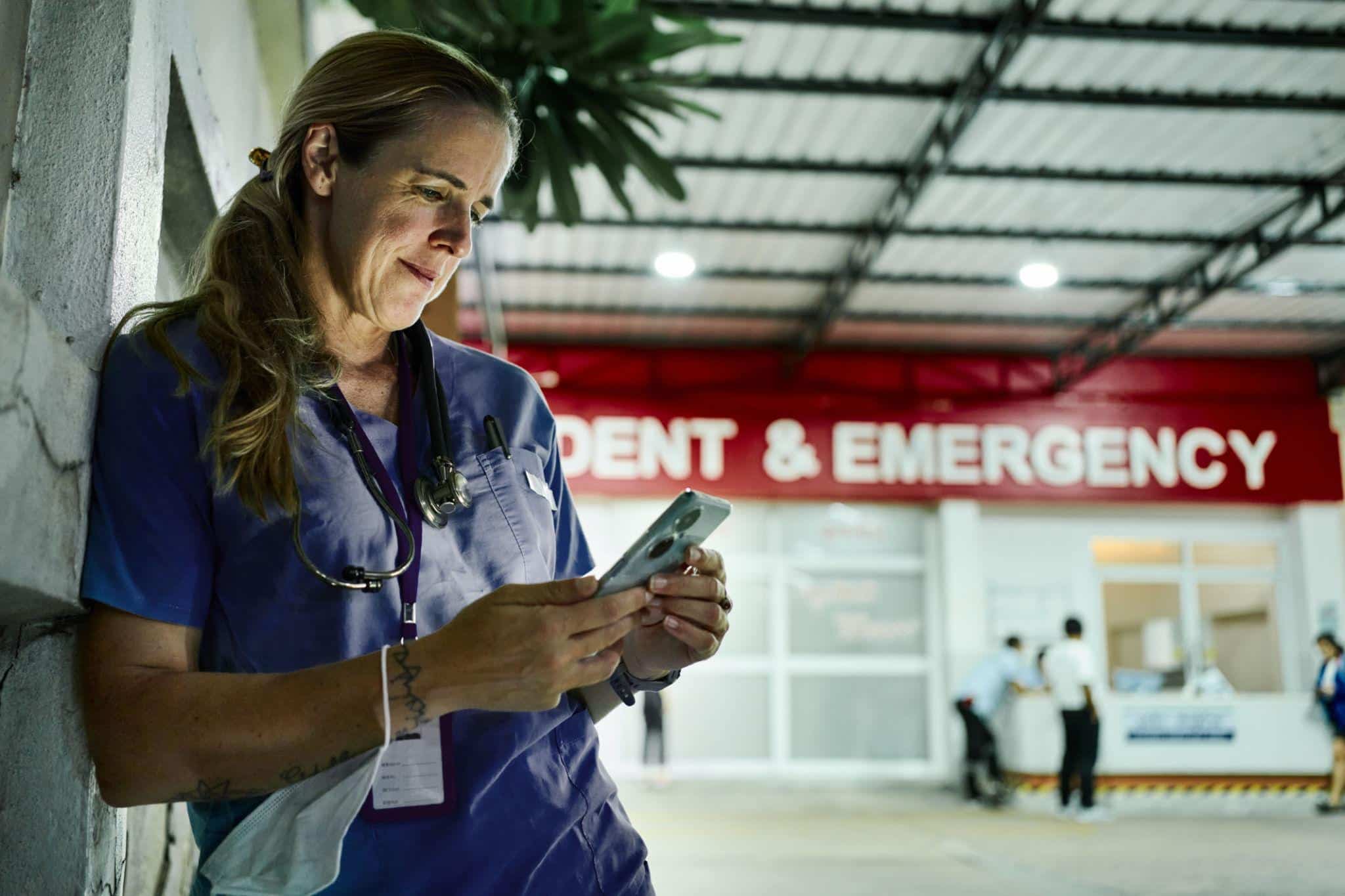 Nurse working overnight third shift resting in quiet hospital hallway